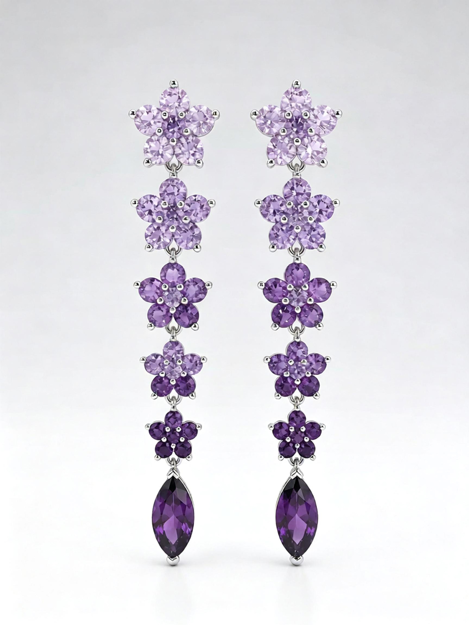 Angled overhead shot luxury wisteria glimmer floral dangle earrings studio shot