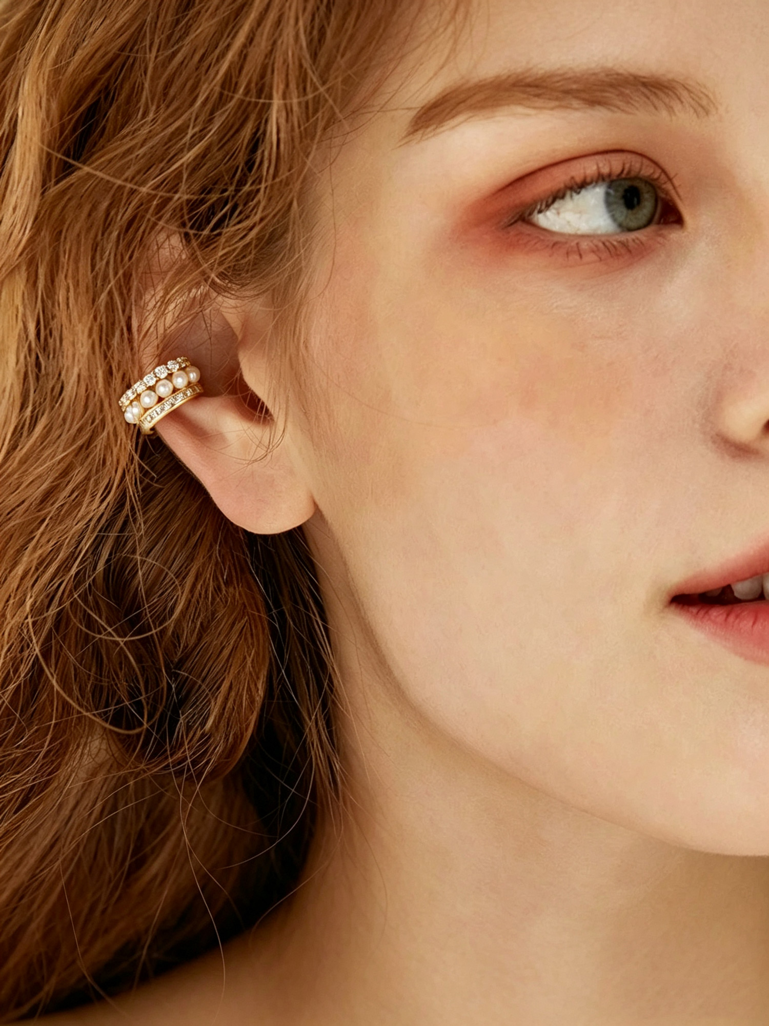 Aurelia Pearl Ear Cuff on model ear, elegant gold tone ear jewelry