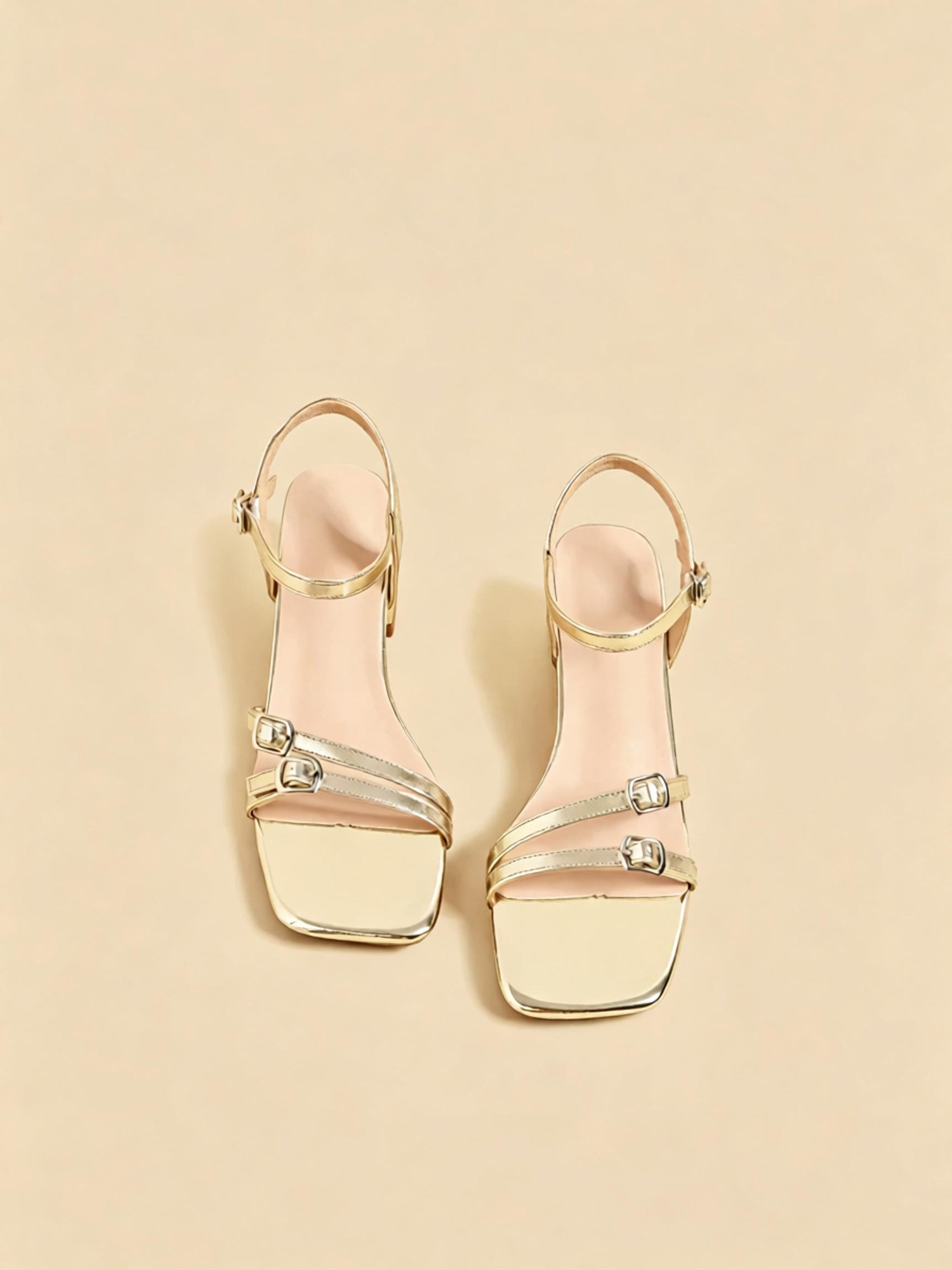 Aurora gleam sandals top view, luminous gold strap detail and square toe