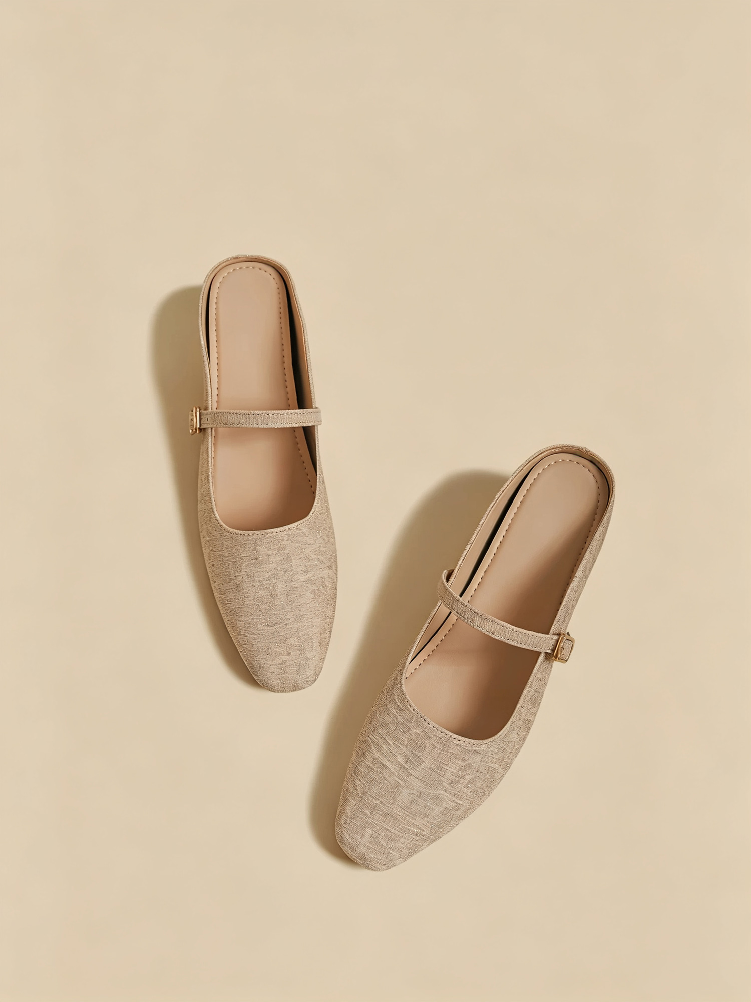 Champagne mary jane mules front closeup, adjustable instep buckle and subtle texture