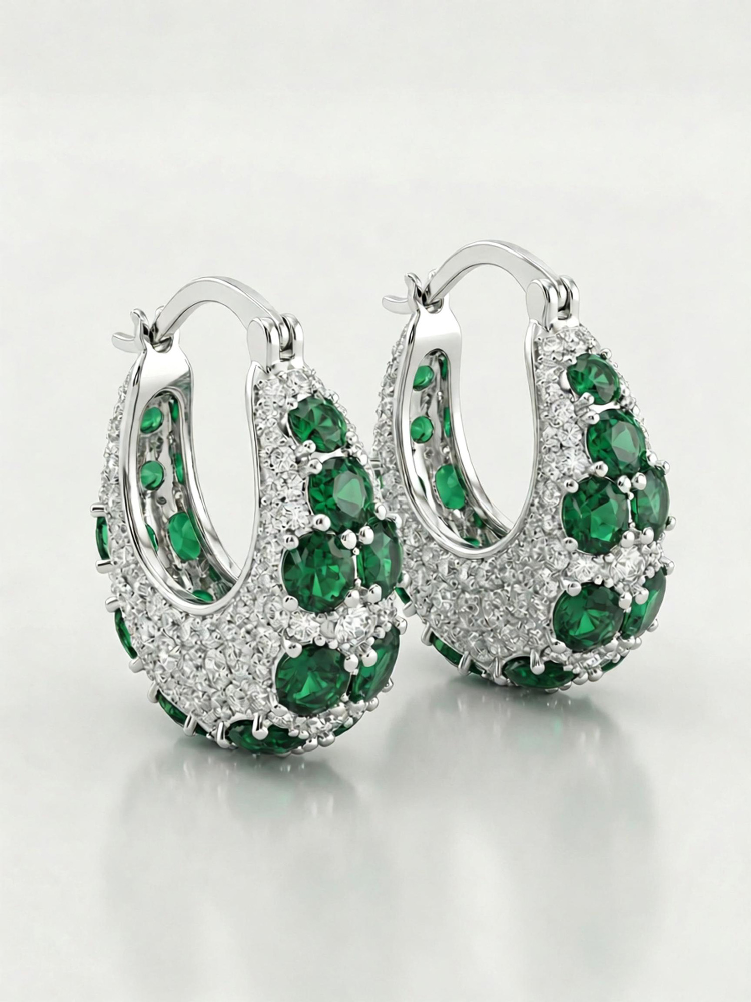 Close‑up shot green galaxy hoop earrings emerald zircon and clear zircon detailing
