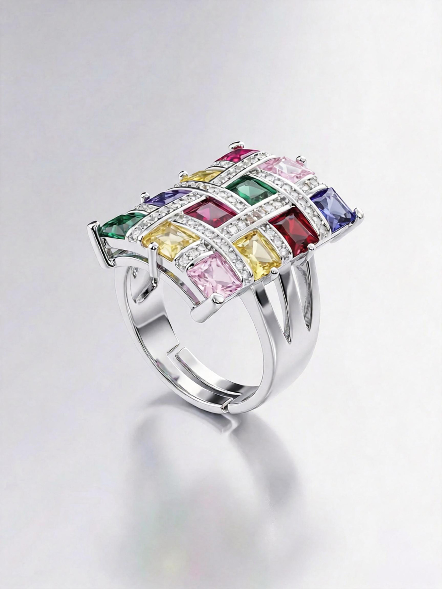 Colorful spectrum ring close‑up, rectangular face with pink yellow green purple blue red zircon layout
