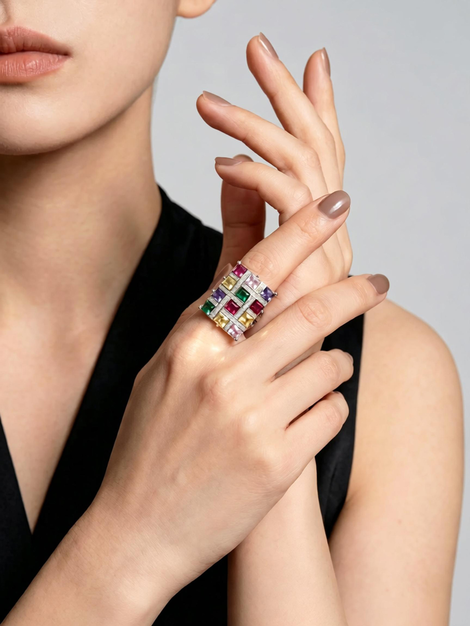 Colorful spectrum ring resting on natural stone, vibrant rainbow zircon mosaic with clear zircon borders
