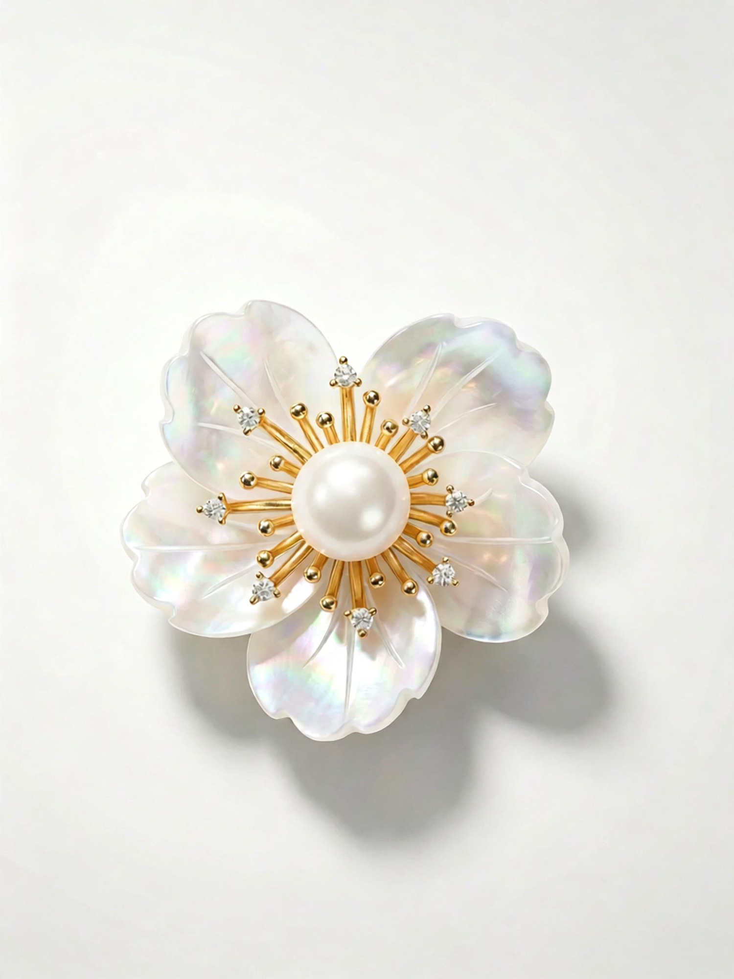 Golden radial stem detail with tiny clear zircon accents on camellia pearl brooch