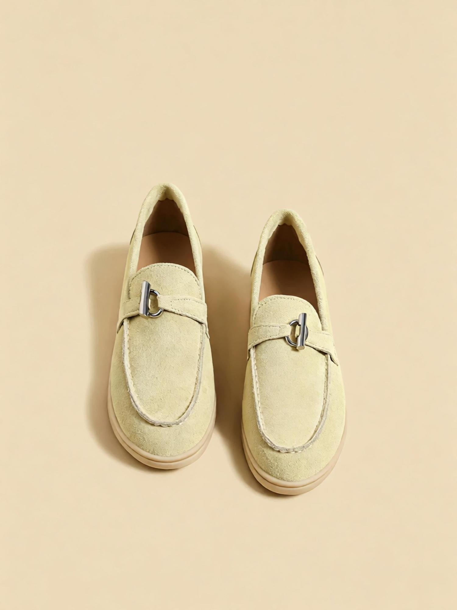 Melon green loafers front close up, polished metal buckle and hand stitching detail