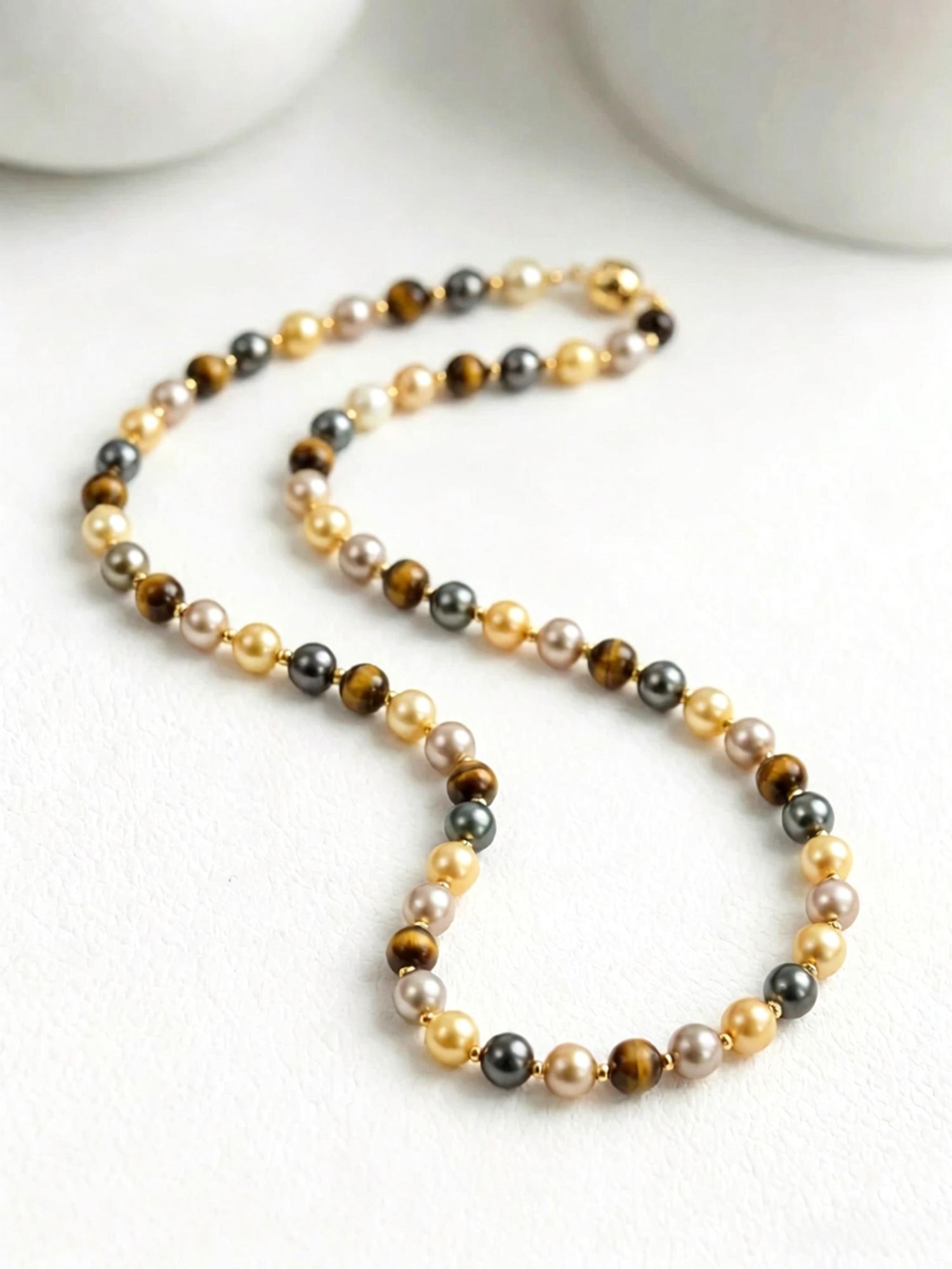 Mixed earth tone beaded necklace close‑up, 8mm south sea tahitian champagne pearl and tiger eye bead detail