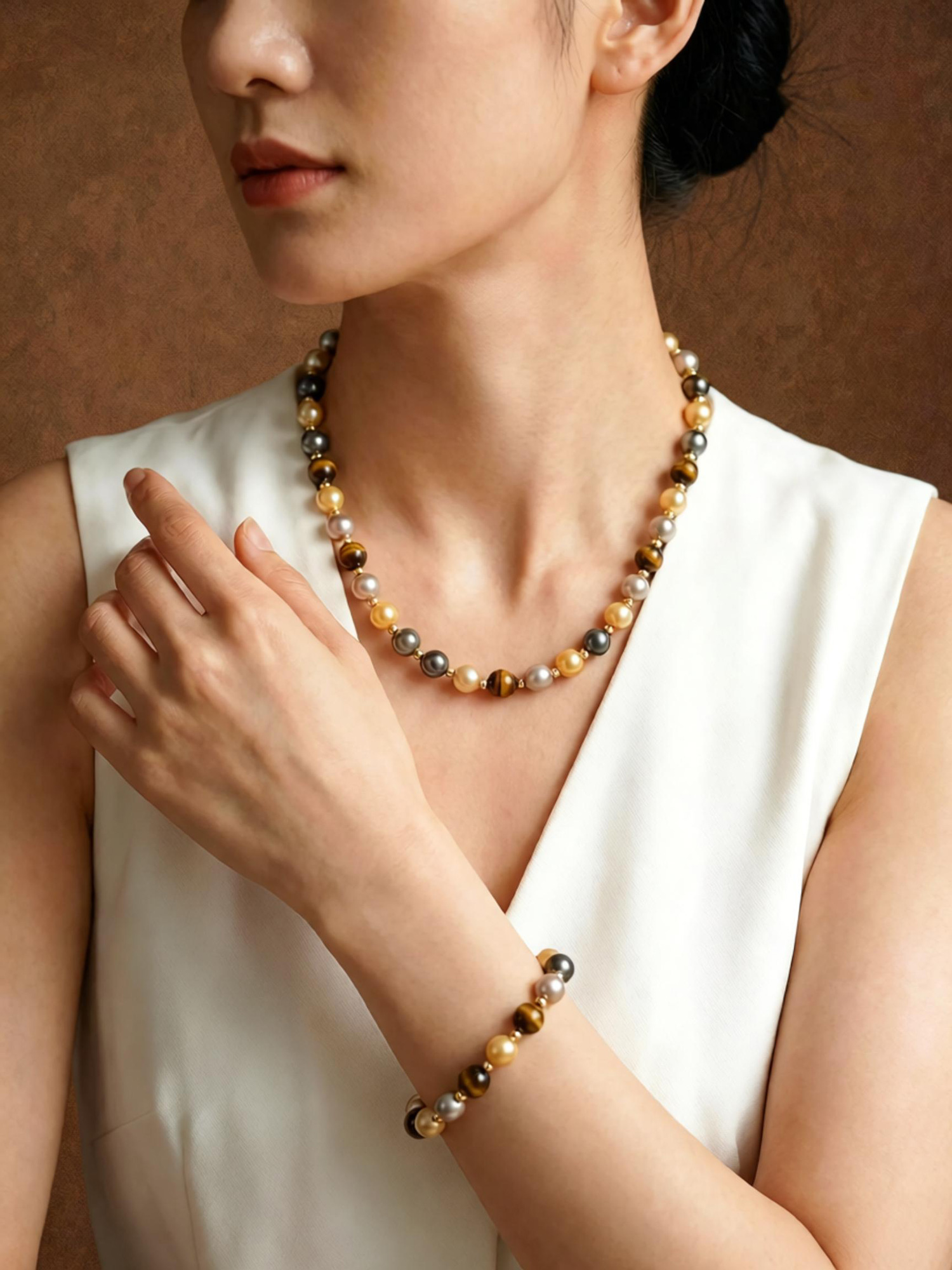 Mixed earth tone beaded necklace flat lay, alternating tiger eye and multi‑color pearl beads