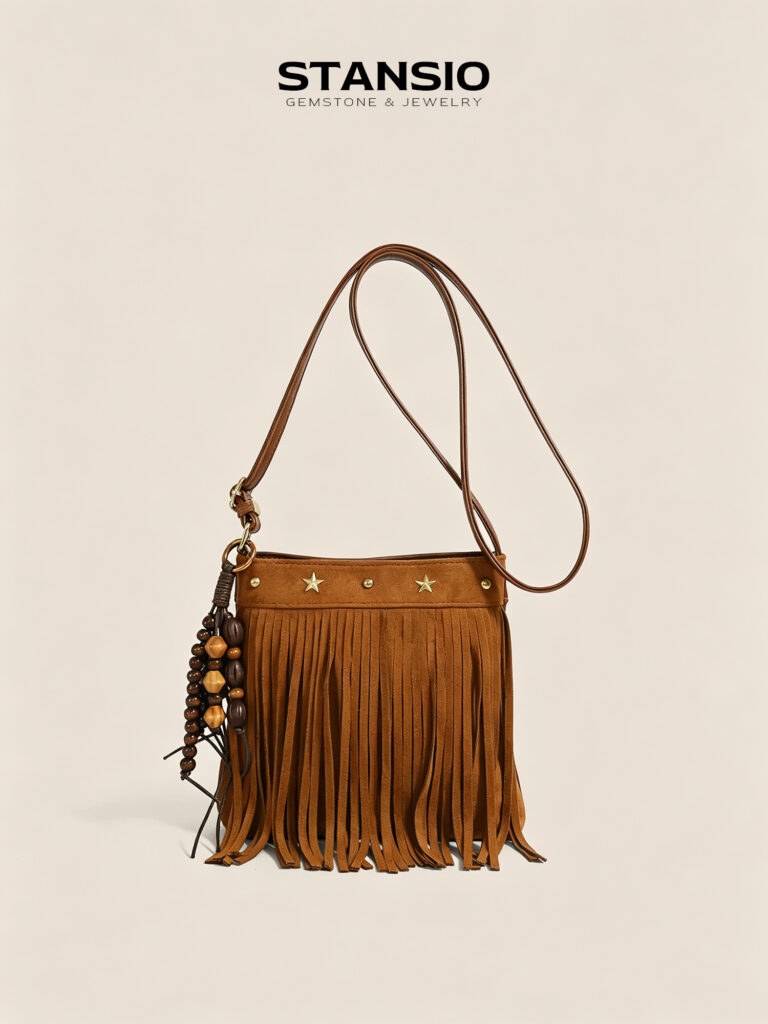 STANSIO brown boho fringe crossbody bag with star studs and wooden bead tassel on beige background