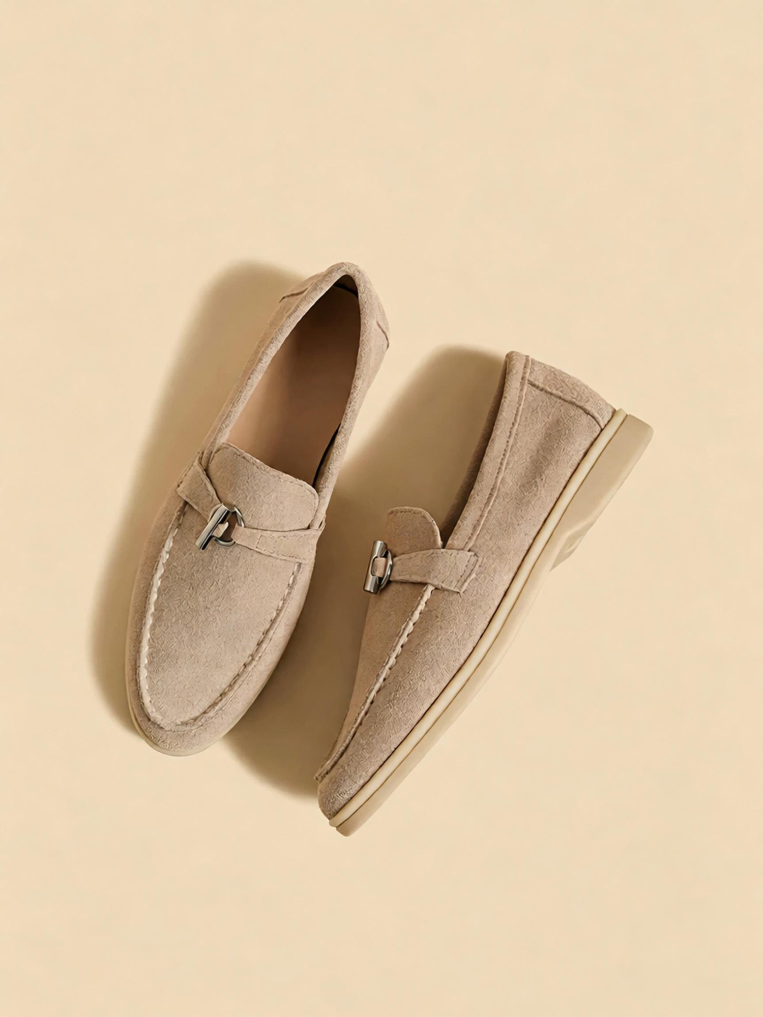 Sand apricot loafers front close up, polished metal buckle and hand stitching detail