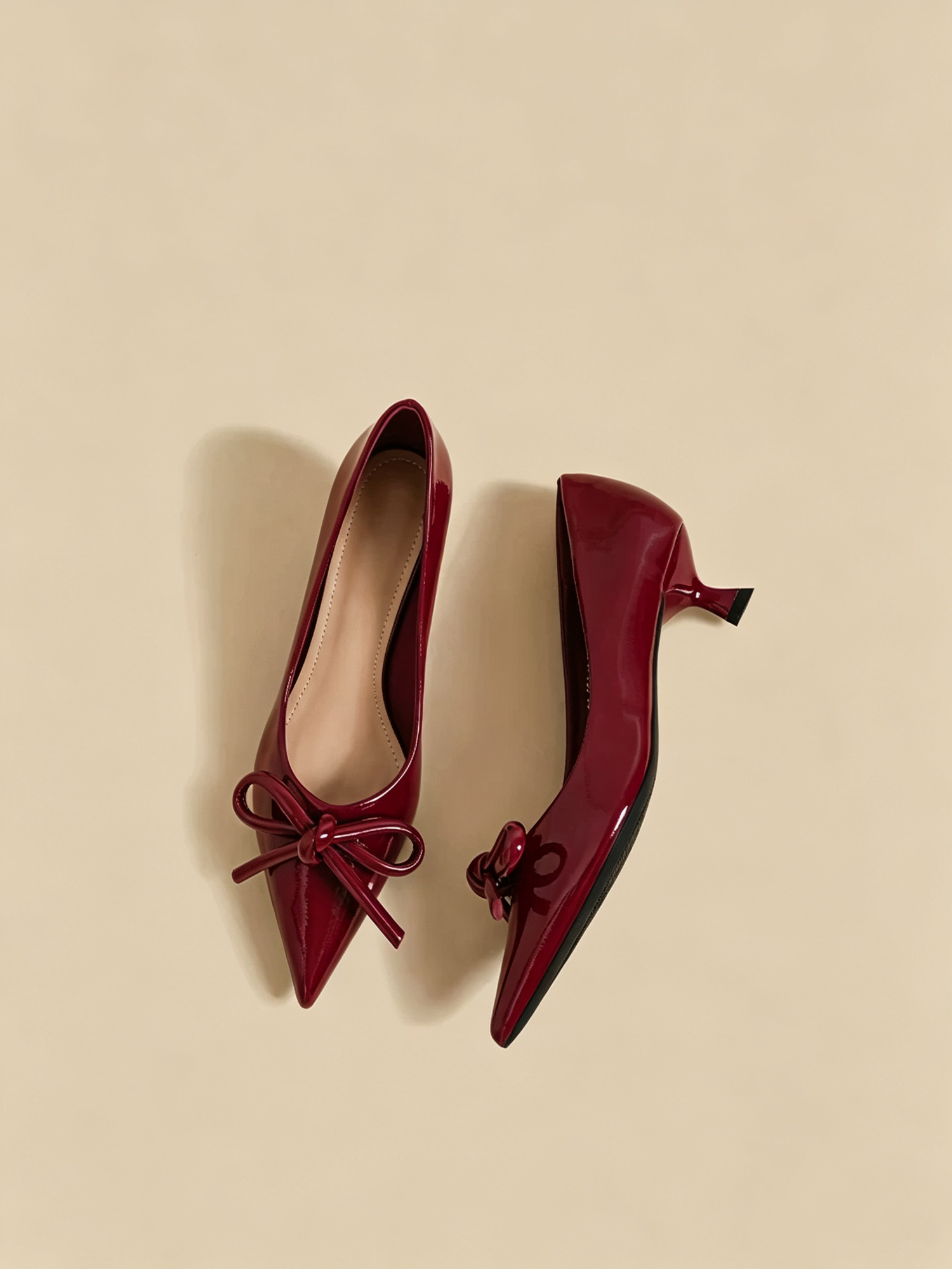 Scarlet bow heels front view, elegant red pumps with front bow detail