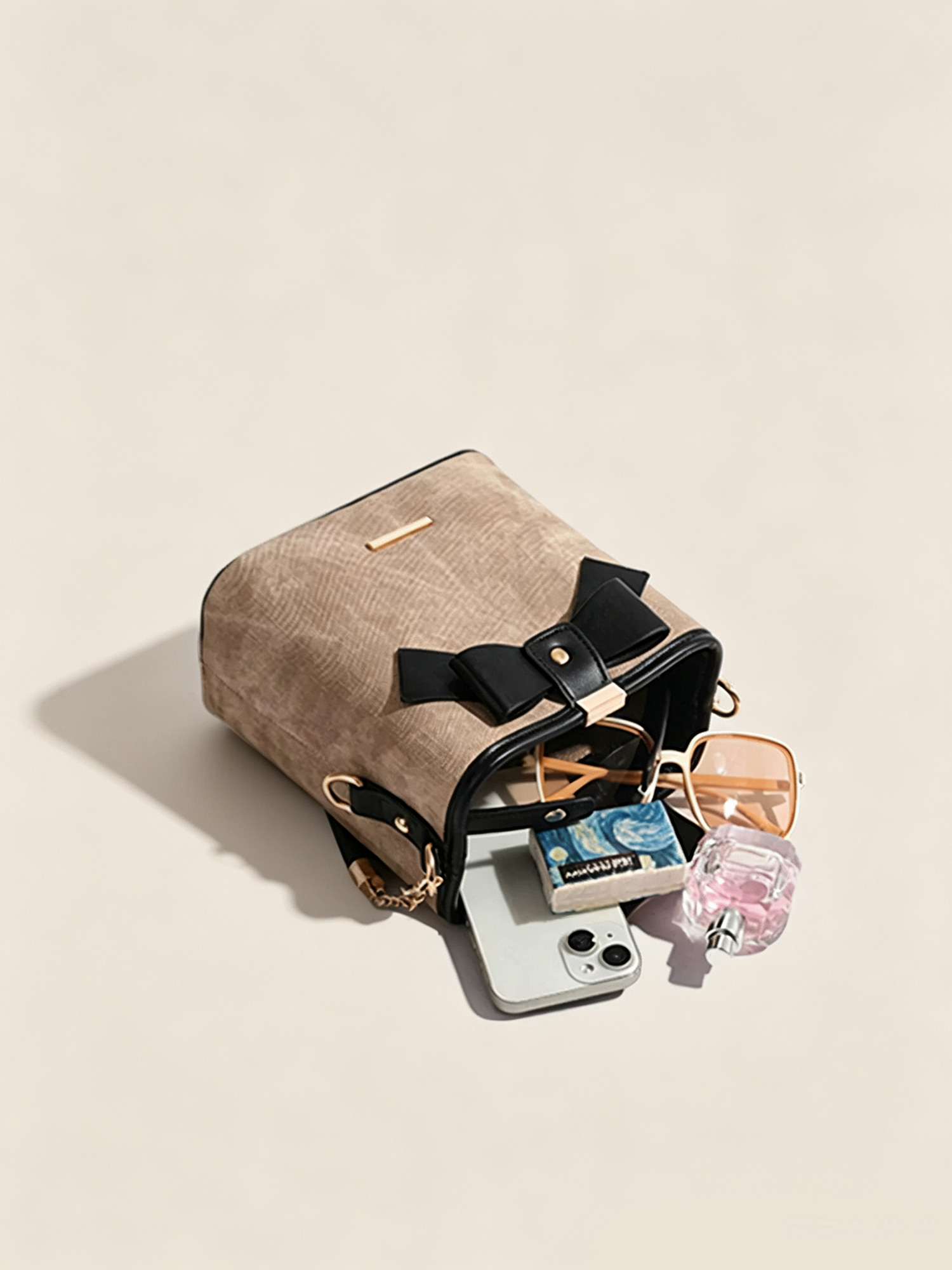 Side angle shot of retro bucket bag with detachable crossbody strap and gold hardware
