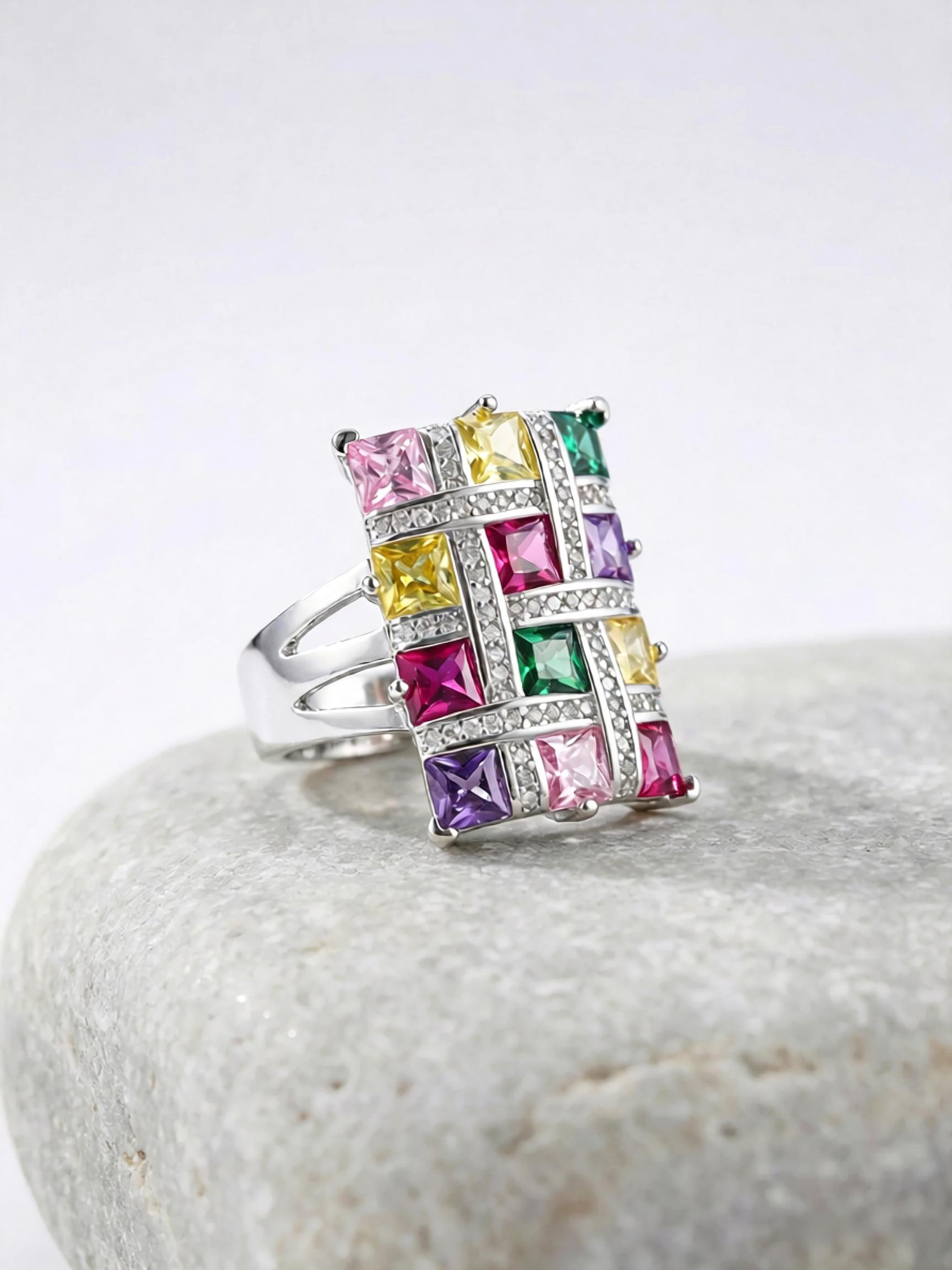 Side profile of colorful spectrum ring, polished platinum tone split shank band with open adjustable gap
