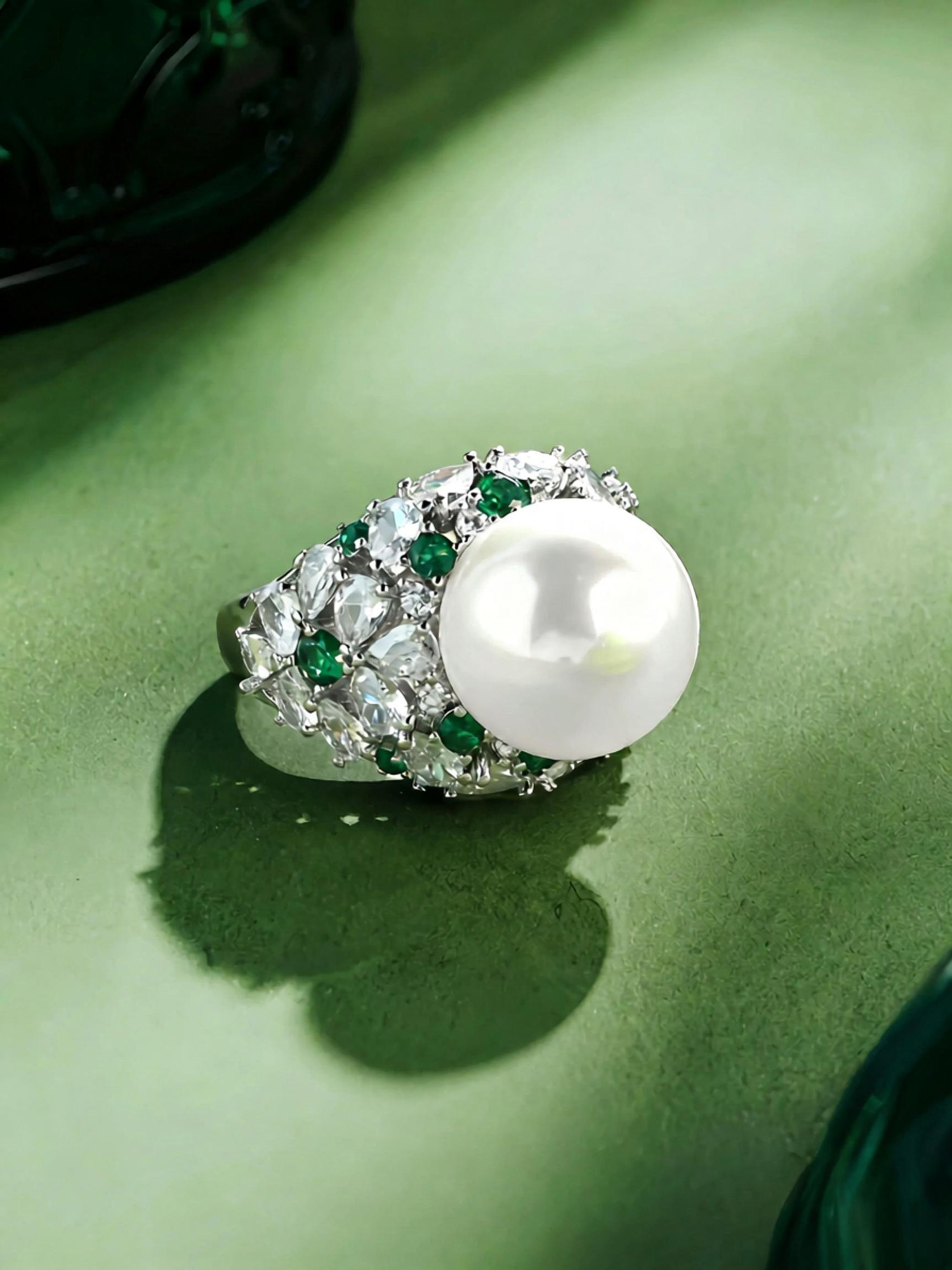 Side view of floating pearl ring, polished copper 18k gold plated band and pearl halo setting