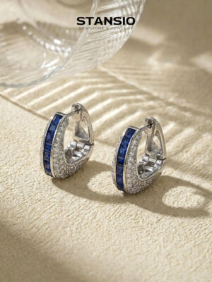 Stansio blue elegance hoop statement earrings on textured beige stone background