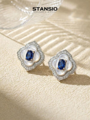 Stansio blue vow clover stud earrings on clean light grey studio background