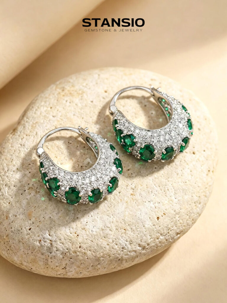 Stansio green galaxy hoop statement earrings on natural stone background