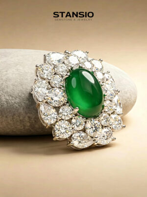 Stansio green grace brooch laid on neutral tone stone surface