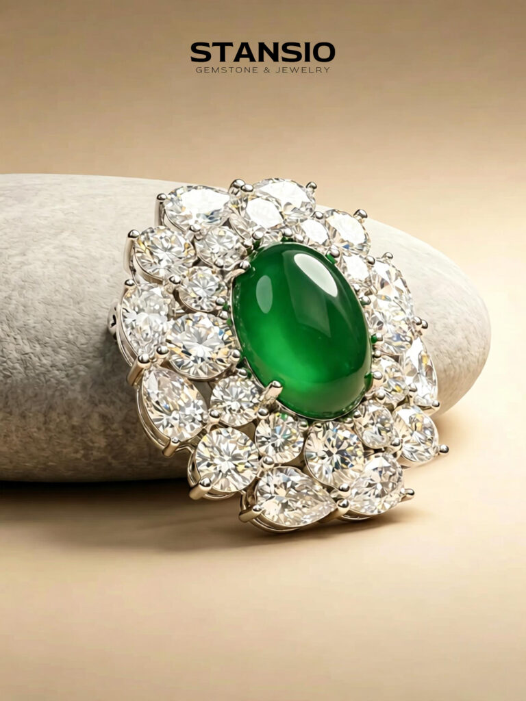 Stansio green grace brooch laid on neutral tone stone surface