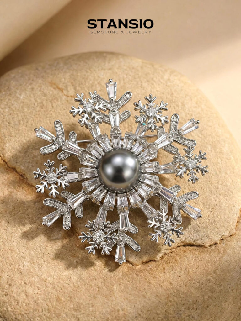 Stansio snow tahiti pearl brooch pinned on soft beige shawl on model